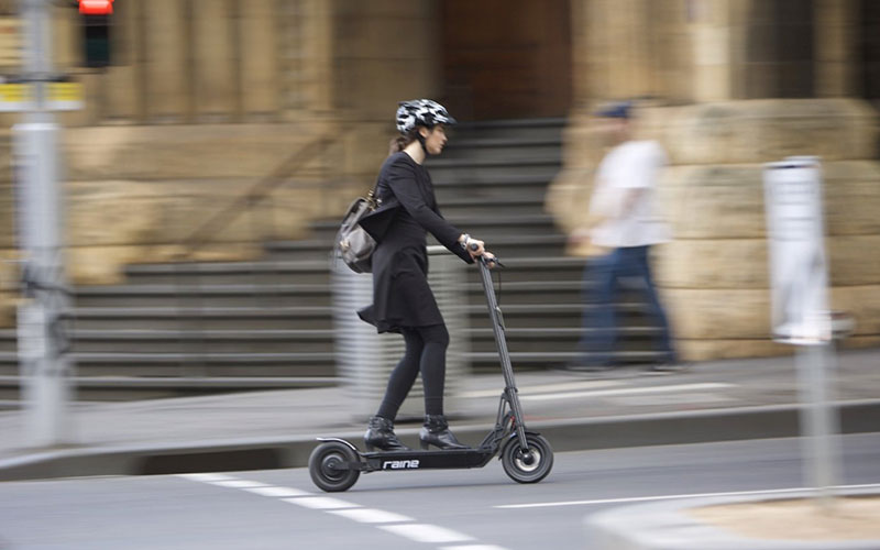 Electric Scooter Benefits - Woman Riding E-Scooter